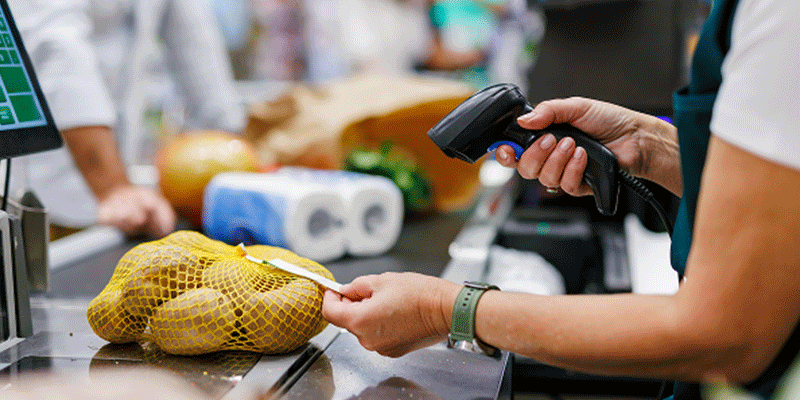 Person scanning a bag of potatoes at a grocery store